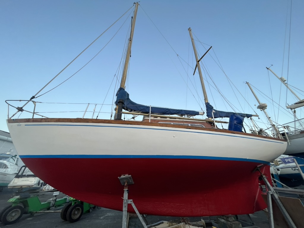 After: fresh white topsides, a blue boot stripe and new red antifoul