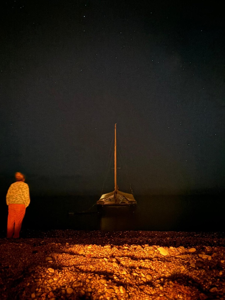 A lone figure on the sand at dusk