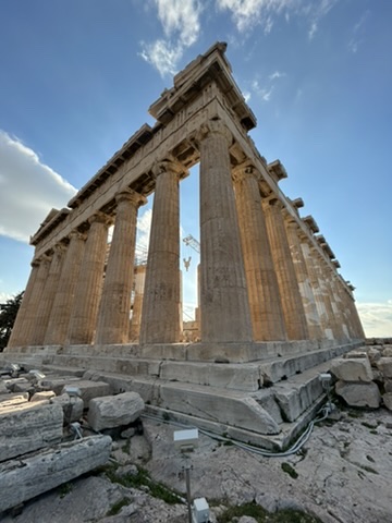 Ancient stone temple ruins with standing columns on a hillside